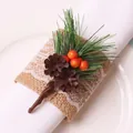 Christmas napkin ring with pine cones, red berries, and lace burlap on a white plate - Red Berry Double Pine Cone Jute Lace Style