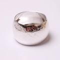 Macro detail of silver napkin ring with elegant rose relief pattern and polished finish - Relief Silver / Silver