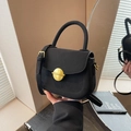Women's black suede semi-circle handbag featuring a prominent round gold metal buckle - Black