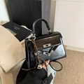 Mini black glossy leather Kelly-style handbag with silver hardware and woven pendant - With Pendant / Black