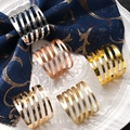 Spiral hollow metal napkin rings in silver, gold, and rose gold on a ceramic plate - Spiral Geometric Style (ZWZ-INR-140)