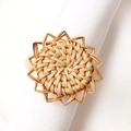 Detailed view of handmade rattan napkin ring in sunburst shape for table decor - Sunflower Woven Style