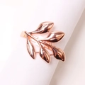 Polished rose gold leaf napkin ring on a white cloth for elegant table decoration - Rose Gold