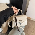 Creamy white Kelly style crossbody bag with glossy finish and silver hardware clasp - With Pendant / Off White