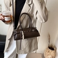 Minimalist dark brown leather baguette shoulder bag with stylish grommet strap and charms - With Pendant / Coffee