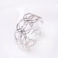 Detailed close-up of a silver woven metal napkin ring with luxury mesh texture design - Silver