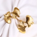 Golden ginkgo leaf napkin ring set with detailed metallic texture on white cloth - Gold