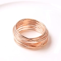 Macro view of multi-layered wire-wrapped rose gold napkin ring with metal wire texture - Rose Gold