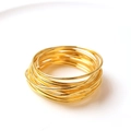 Close-up of golden electroplated wire napkin rings with multilayered metal loops - Gold