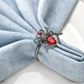 Halloween spider napkin ring with red crystal stone on light blue fabric and white plate - Red Gem Black Spider Style (7)