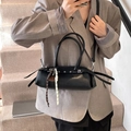 Chic black PU leather cylinder bag with woven pendants on stylish grey suit model - With Pendant / Black