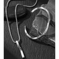 Detail of silver twisted pendant necklace and cuff bracelet on dark leather and stone - Twisted Spiral Style (F28)