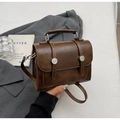 Detail of vintage brown leather handbag with silver buckles and elegant round handle - No Pendant / Brown