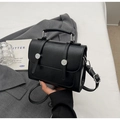 Close-up of black PU leather satchel bag with silver buckles and adjustable strap - No Pendant / Black