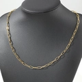 Close-up of a gold paperclip chain necklace displayed on a black matte bust model - 45cm / Gold