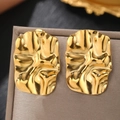 Close-up of gold geometric square earrings with a hammered metal texture and high polish - Gold (C6291)