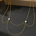 Detail of layered gold body chain featuring elegant white pearl accents on black background - Gold (C5969)