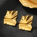 Macro view of gold square stud earrings with irregular pleated texture on black leather - Golden Irregular Folded Style (C6279)