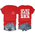 Flat lay of red cotton t-shirt featuring hair stylist era print and blue denim shorts - S / Tops / Red