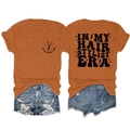 Front and back view of orange Hair Stylist Era T-shirt with blue ripped denim shorts - S / Tops / Burnt Orange