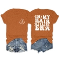 Detail view of the retro hair stylist print on a comfortable orange crew neck t-shirt - S / Tops / Burnt Orange (White Print)
