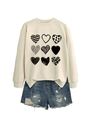 Detail of cream sweatshirt with nine heart patterns and distressed denim shorts with frayed edges - Sand (Black Print)
