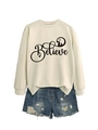 Detail of cream sweatshirt with Believe print and side-slit hem paired with ripped denim shorts - S / Sand with Black Graphic