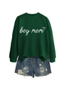 Flat lay of a green crew neck sweatshirt with boy mom text and distressed denim shorts - Dark Green (White Font)