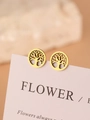 Close-up of golden Tree of Life earrings with intricate laser-cut detail on a pink card - Gold Hollow Tree of Life Style (N4027)