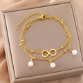 Double-layered gold infinity bracelet with triple pearl charms on a premium jewelry box - Gold (B4255)