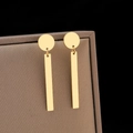 Minimalist gold geometric drop earrings with vertical bar pendant on a jewelry box - Gold (N5875)