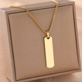 Gold rectangular bar necklace with heart cutout and box chain on brown leather box - Gold Rectangle Pendant (B3873)