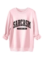 Close-up of pink crewneck sweatshirt featuring Sarcasm slogan and ribbed cuffs detail - Pink