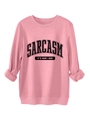 Close-up of pink crewneck sweatshirt featuring black Sarcasm letter print and ribbed cuffs - Peach