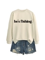 Flat lay of off-white long sleeve sweatshirt with fishing print and ripped denim shorts - Sand (Black Font)