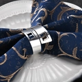 Polished silver metal napkin ring with geometric square design on a blue napkin - Geometric Hollow Squares / Silver