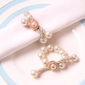 Elegant pearl napkin ring with silver twisted rope and golden rim on white dish - Pearl Twisted Rope Style