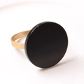 Détail d'un rond de serviette minimaliste avec disque noir et anneau en métal doré - Noir