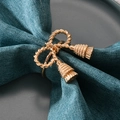 Golden bowknot napkin ring with twisted rope design and tassels on a table setting - Matte Gold