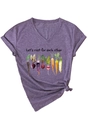Detail of purple V-neck T-shirt with watercolor root vegetable prints and inspirational text - Purple (Black Graphic)