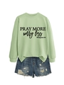 Detail of Pray More Worry Less print on light green long sleeve crewneck sweatshirt - S / Olive Green (Black Font)