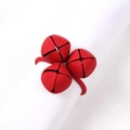Christmas napkin ring with three matte red bells on a white fabric napkin cloth - Red