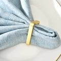 Modern minimalist rectangle gold metal napkin ring with a brushed matte finish on a table - Gold