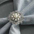 Floral silver metal napkin ring with pearl and rhinestones on light blue fabric - Silver