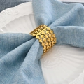 Elegant gold metal napkin ring with four-layer wavy hollow design on blue linen napkin - 1 Piece / Gold
