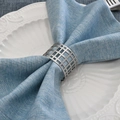 Modern geometric hollow metal napkin ring in matte silver on a blue cloth napkin - Silver Hollow Grid Napkin Ring