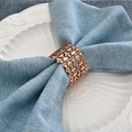Macro detail of rose gold wavy镂空 napkin ring on a textured blue linen cloth - 1 Piece / Rose Gold (4)