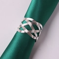 Handwoven silver metal napkin ring with hollow knot design on dark green satin cloth - Silver