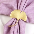 Elegant gold ginkgo leaf napkin ring made of metal alloy on a purple cloth napkin - Matte Gold Ginkgo Leaf Napkin Ring