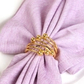 Spiral gold metal napkin ring with textured finish and spherical accents for table decor - Gold